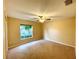 Spacious bedroom with ceiling fan and window at 16026 Sw 14Th Avenue Rd, Ocala, FL 34473