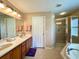 Double vanity bathroom with walk-in shower and separate tub at 16026 Sw 14Th Avenue Rd, Ocala, FL 34473