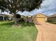 Well-maintained house with a two-car garage and landscaped yard at 16026 Sw 14Th Avenue Rd, Ocala, FL 34473