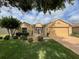 House with manicured lawn, landscaping, and a large tree at 16026 Sw 14Th Avenue Rd, Ocala, FL 34473