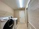Bright laundry room with washer, dryer, and ample shelving at 16026 Sw 14Th Avenue Rd, Ocala, FL 34473