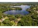 Aerial view of lakefront property with home and tranquil surroundings at 15669 Se 112Th Ln, Ocklawaha, FL 32179