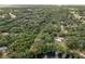 Aerial view showing home nestled in a verdant landscape near the water at 15669 Se 112Th Ln, Ocklawaha, FL 32179