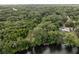 Aerial view of waterfront property with home and lush green surroundings at 15669 Se 112Th Ln, Ocklawaha, FL 32179