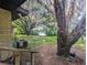 Large backyard with mature trees and a view of the lake at 15669 Se 112Th Ln, Ocklawaha, FL 32179
