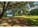 Relaxing backyard with lake access and seating area at 15669 Se 112Th Ln, Ocklawaha, FL 32179
