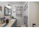Bathroom with teal vanity, shower/tub combo, and patterned curtain at 15669 Se 112Th Ln, Ocklawaha, FL 32179