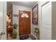 Inviting entryway with wood door and decorative wall art at 15669 Se 112Th Ln, Ocklawaha, FL 32179