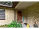 Inviting front entrance with a wooden door and welcome mat at 15669 Se 112Th Ln, Ocklawaha, FL 32179