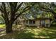 Ranch-style home with mature trees and lush landscaping at 15669 Se 112Th Ln, Ocklawaha, FL 32179
