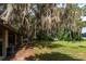 Home's exterior features a covered porch and waterfront view at 15669 Se 112Th Ln, Ocklawaha, FL 32179