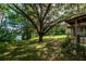 Home exterior showcasing a waterfront view and lush yard at 15669 Se 112Th Ln, Ocklawaha, FL 32179