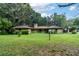 Ranch-style home with a brick facade, situated on a spacious grassy lot with mature trees at 15669 Se 112Th Ln, Ocklawaha, FL 32179