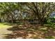 Ranch-style home nestled under large oak trees with Spanish moss at 15669 Se 112Th Ln, Ocklawaha, FL 32179