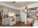 Kitchen with gray cabinets, full-size appliances, and pantry at 15669 Se 112Th Ln, Ocklawaha, FL 32179