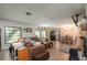Spacious living area featuring a cozy fireplace and ample natural light at 15669 Se 112Th Ln, Ocklawaha, FL 32179