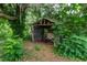 Overgrown storage shed in the backyard at 15669 Se 112Th Ln, Ocklawaha, FL 32179