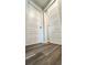 Hallway with two white doors and grey vinyl plank flooring at Tbd Bay Place Crse, Ocklawaha, FL 32179