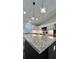 Kitchen island with granite countertop and pendant lighting at Tbd Bay Place Crse, Ocklawaha, FL 32179
