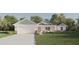 One-story home with light teal siding, white accents, and landscaping at Tbd Bay Pl, Ocklawaha, FL 32179