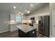 Modern kitchen with white cabinets, granite island, and stainless steel appliances at Tbd Fisher Lane Trak, Ocklawaha, FL 32179