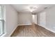 Bedroom with wood-look flooring, ceiling fan, and access to bathroom at 13359 Sw 80Th St, Dunnellon, FL 34432