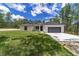 Newly built home with gray garage door and green lawn at 13359 Sw 80Th St, Dunnellon, FL 34432