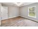 Bedroom with wood-look flooring, ceiling fan and window at 13359 Sw 80Th St, Dunnellon, FL 34432