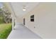 Covered back patio with ceiling fans and sliding glass doors at 13359 Sw 80Th St, Dunnellon, FL 34432