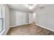 Bedroom with wood-look floors, ceiling fan, and double doors to closet at 13359 Sw 80Th St, Dunnellon, FL 34432