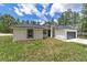One-story home with gray garage and white exterior at 13359 Sw 80Th St, Dunnellon, FL 34432