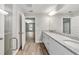 Bathroom with double vanity, granite countertop and view into a bedroom at 13359 Sw 80Th St, Dunnellon, FL 34432