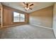 Bright bedroom with carpeted floors and large window at 115 Malauka Radl, Ocklawaha, FL 32179