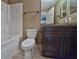 Clean bathroom with dark wood vanity and a bathtub shower combo at 115 Malauka Radl, Ocklawaha, FL 32179