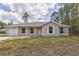 Single-story home with attached garage and front porch at 48 Malauka Dr, Ocklawaha, FL 32179