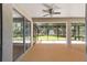 Spacious screened porch with ceiling fan and access to backyard at 10020 Sw 202Nd Cir, Dunnellon, FL 34431