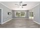 Bright living room with vinyl flooring, large windows, and sliding glass doors at 10020 Sw 202Nd Cir, Dunnellon, FL 34431