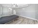 Bright bedroom with grey walls, wood-look floors, and ceiling fan at 10020 Sw 202Nd Cir, Dunnellon, FL 34431