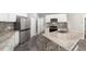 Modern kitchen with white cabinets, granite countertops, and stainless steel appliances at 10020 Sw 202Nd Cir, Dunnellon, FL 34431
