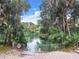 Inviting natural spring with steps and a surrounding fence at 10020 Sw 202Nd Cir, Dunnellon, FL 34431