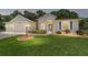 One-story home with two-car garage and landscaping at 10020 Sw 202Nd Cir, Dunnellon, FL 34431