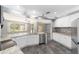 Modern kitchen with white cabinets, granite countertops, and stainless steel appliances at 10020 Sw 202Nd Cir, Dunnellon, FL 34431