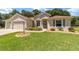 Two-car garage, single-story home exterior at 10020 Sw 202Nd Cir, Dunnellon, FL 34431