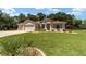 Single story home with a large yard and two car garage at 10020 Sw 202Nd Cir, Dunnellon, FL 34431