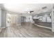 Open concept living room and kitchen with wood-look vinyl flooring at 10020 Sw 202Nd Cir, Dunnellon, FL 34431