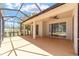 Extended screened porch with multiple sliding glass doors and a view at 10020 Sw 202Nd Cir, Dunnellon, FL 34431
