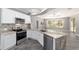 Modern kitchen with white cabinets, granite countertops, and stainless steel appliances at 10020 Sw 202Nd Cir, Dunnellon, FL 34431