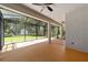 Large screened porch with ceiling fans, offering a relaxing outdoor space at 10020 Sw 202Nd Cir, Dunnellon, FL 34431