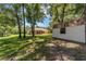 Back exterior view of a home with a screened porch and detached shed at 10020 Sw 202Nd Cir, Dunnellon, FL 34431
