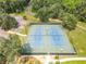 Two lighted tennis courts in a community setting at 10020 Sw 202Nd Cir, Dunnellon, FL 34431